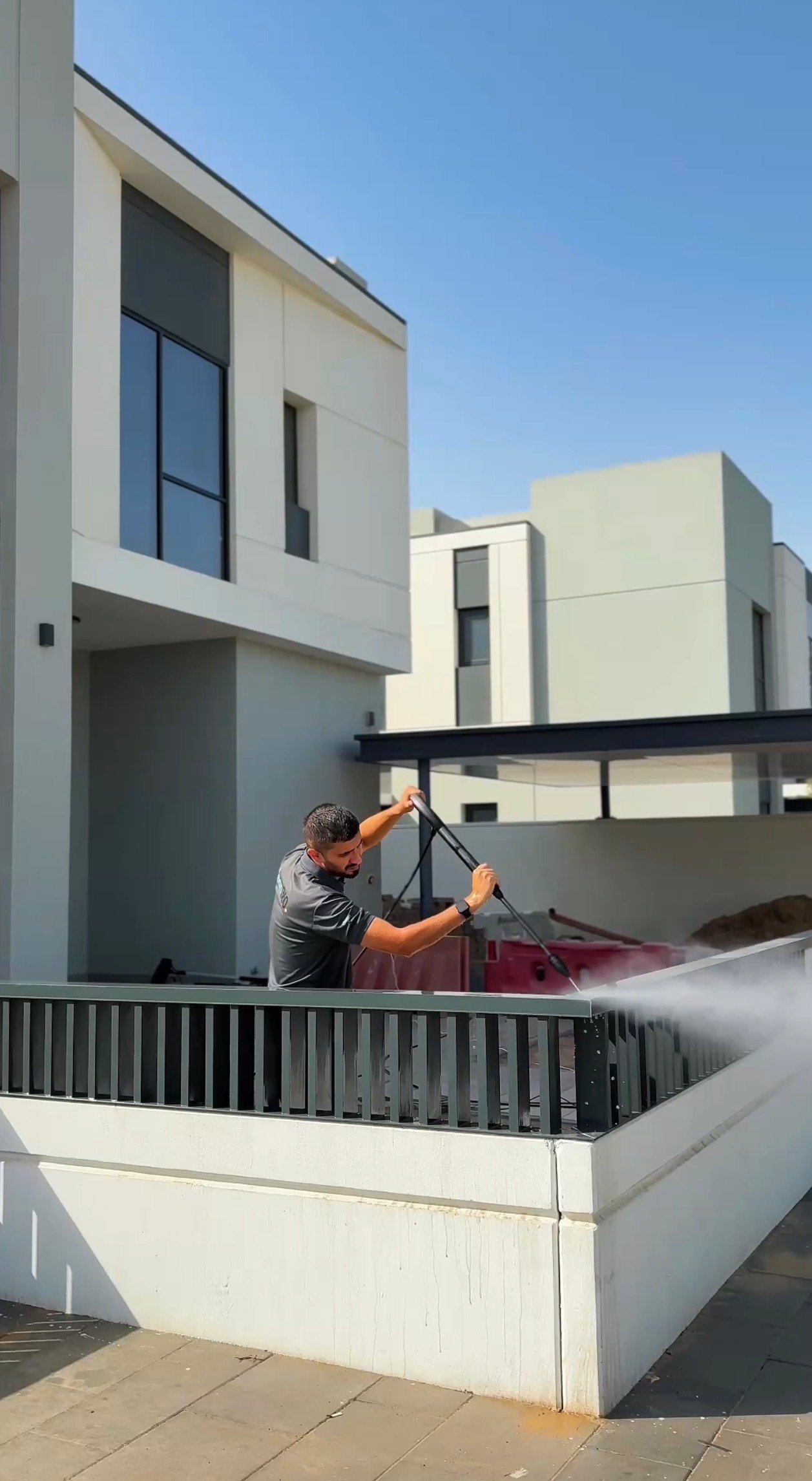 Clean360 technician pressure washing a villa exterior in Dubai